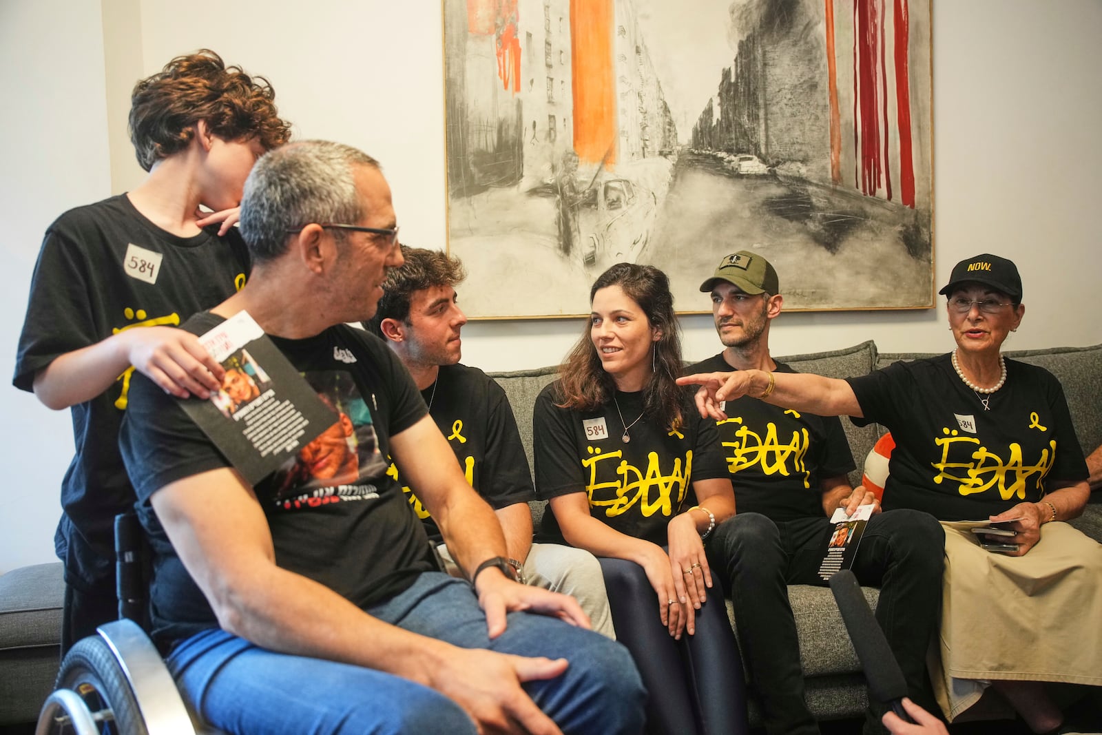 Relatives and friends of Israeli-American soldier Edan Alexander gather to watch the TV broadcast of his release from Hamas captivity in Gaza, in Tel Aviv, Monday, May 12, 2025. Alexander was abducted during the Hamas-led attack on his base on October 7, 2023. (AP Photo/Ohad Zwigenberg)