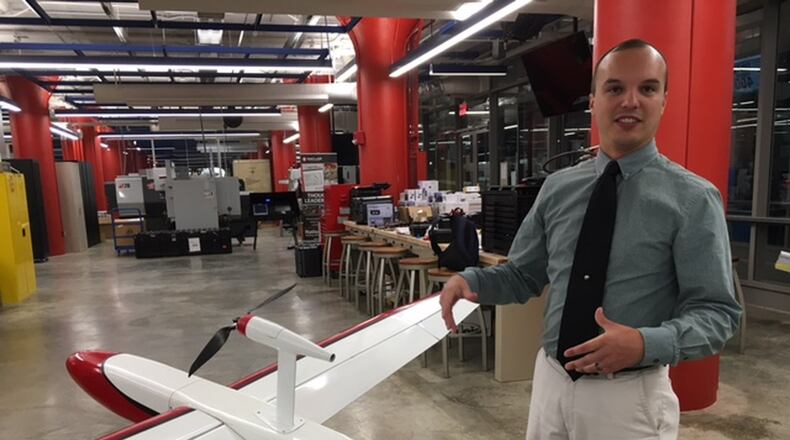 In this file photo, Andrew Shepherd, who heads Sinclair Community College’s unmanned aerial vehicles program, stands next to a version of Unmanned Solutions Technology’s Pelican II fixed-wing UAV. Sinclair is a step closer to offering three bachelor’s degrees, two aviation-related and one in industrial automation. THOMAS GNAU/STAFF ORIGINAL Andrew Shepherd, who heads Sinclair Community College’s unmanned aerial vehicles program, stands next to a version of Unmanned Solutions Technology’s Pelican II fixed-wing UAV in July. THOMAS GNAU/STAFF