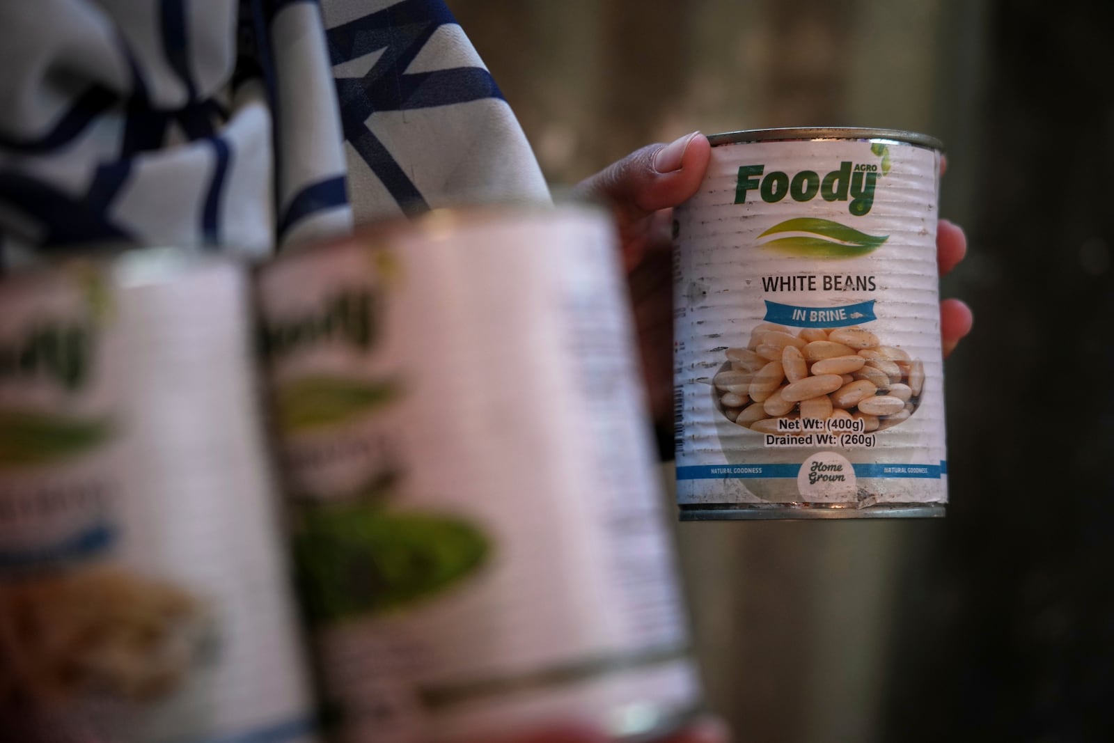 Wedad Abdelaal, whose 9-month-old son Khaled suffers from malnutrition, holds up a can of beans at her tent in a camp for displaced Palestinians in Mawasi Khan Younis, Gaza Strip, Friday, May 2, 2025." (AP Photo/Abdel Kareem Hana)