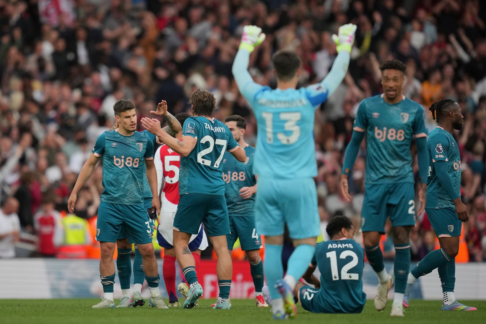 Bournemouth players celebrate at the end of the English Premier League soccer match between Arsenal and Bournemouth at Emirates stadium in London, Saturday, May 3, 2025. (AP Photo/Kin Cheung)