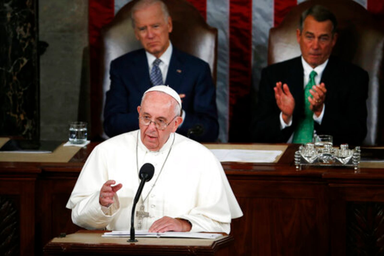 FILE - Pope Francis addresses a joint meeting of Congress on Capitol Hill in Washington, Thursday, Sept. 24, 2015. Listening behind the pope are then Vice President Joe Biden and House Speaker John Boehner of Ohio. (AP Photo/Carolyn Kaster, file)