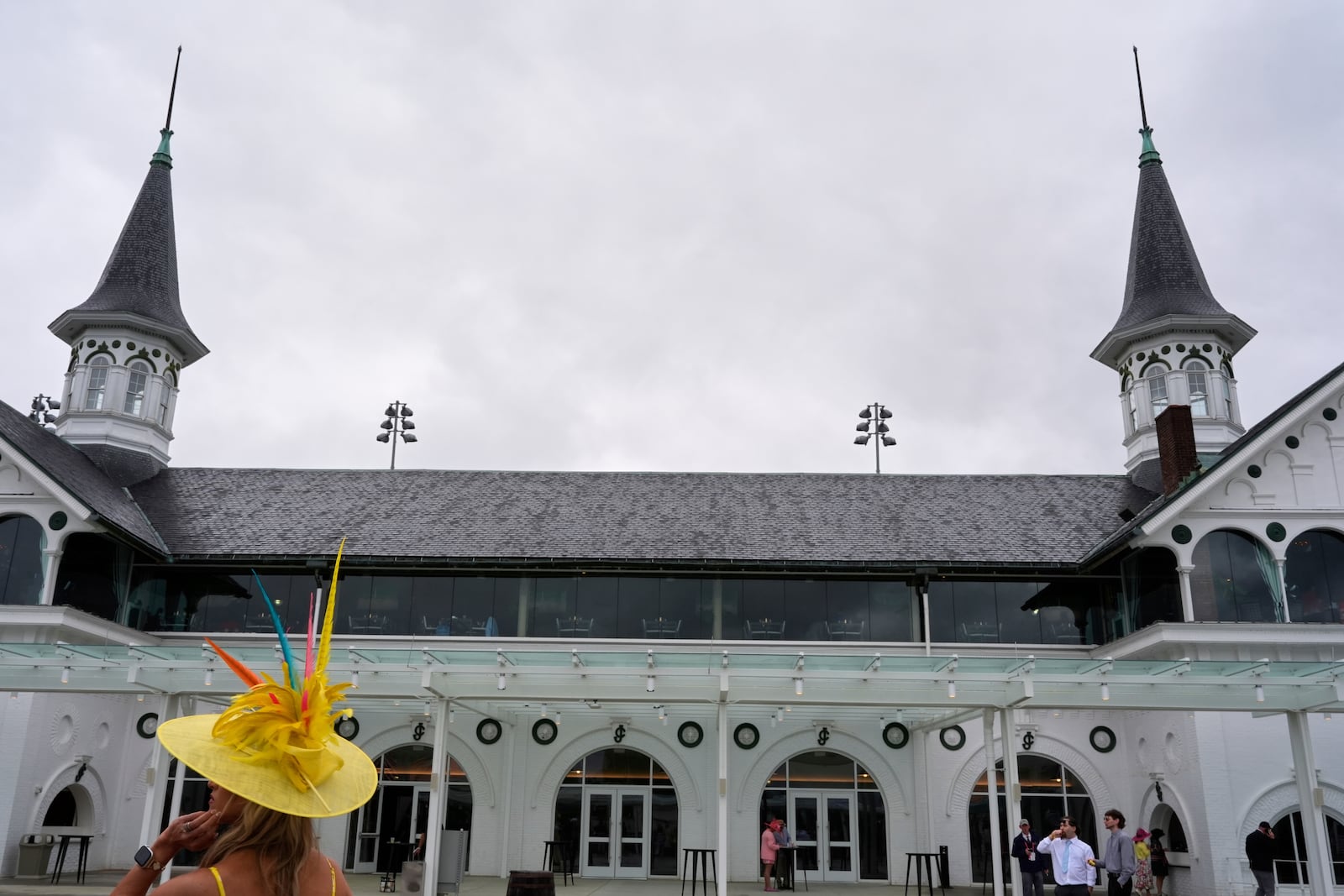 Race fans walk though the grounds at Churchill Downs before the 151st running of the Kentucky Derby horse race Saturday, May 3, 2025, in Louisville, Ky. (AP Photo/Brynn Anderson)