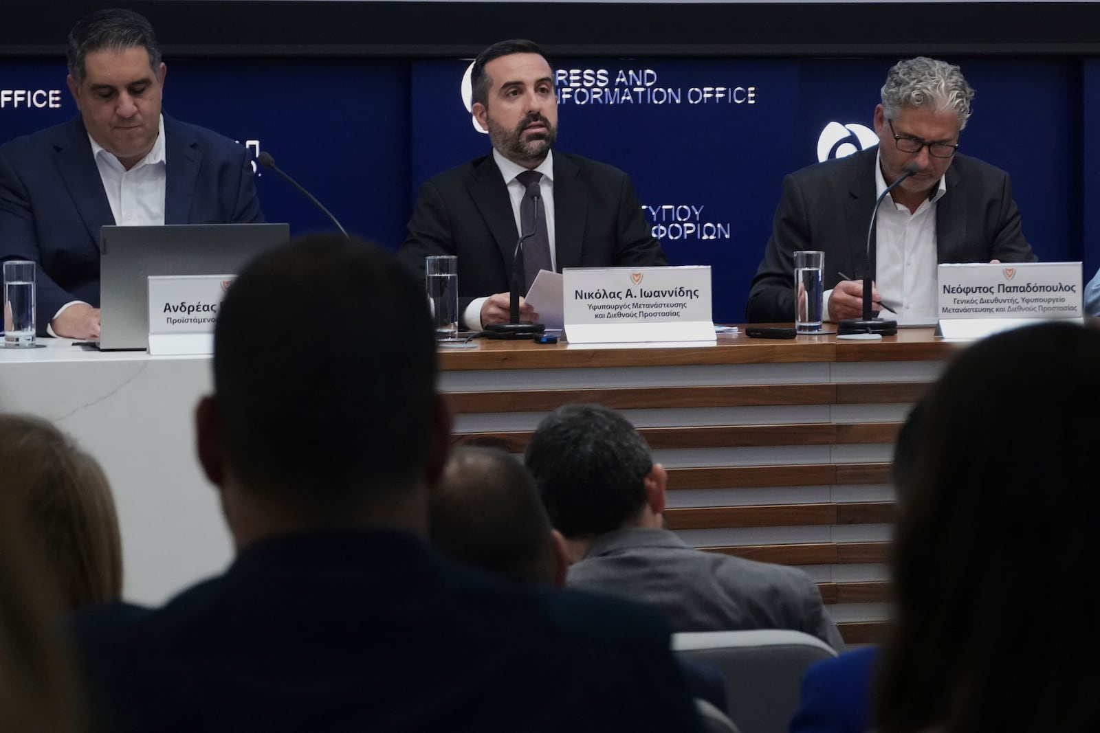 Cyprus' deputy minister for migration Nicholas Ioannides, center, explains how a new voluntary repatriation program for Syrian families living in Cyprus will work during a press conference, at the Press and Informations office in the capital Nicosia, Cyprus, Thursday, May 29, 2025. (AP Photo/Petros Karadjias)