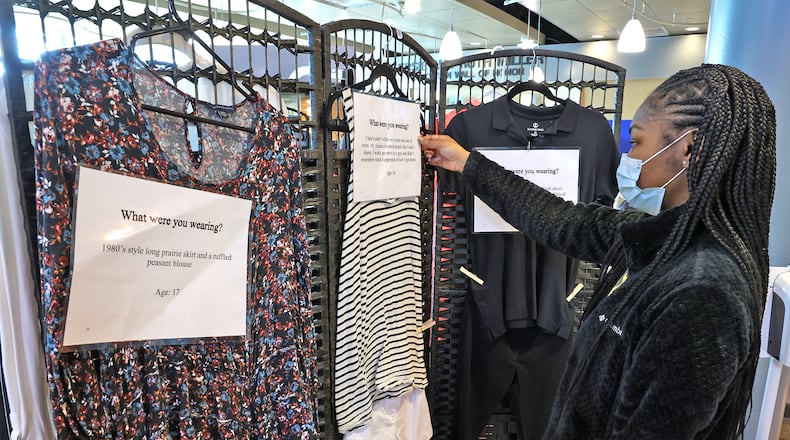 Andrea Hardin, a student at Clark State, reads one of the information tags on the "What Were You Wearing?" sexual assault exhibit on display in the Sara T. Landess Technology and Learning Center Friday. BILL LACKEY/STAFF