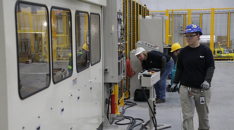 Liz Wikoff, an associate at Topre, works on a 600 ton press in the stamping department of the Springfield factory in 2019. Topre announced on Monday that it would be temporarily stopping production at its Springfield facility for at least two weeks. BILL LACKEY/STAFF