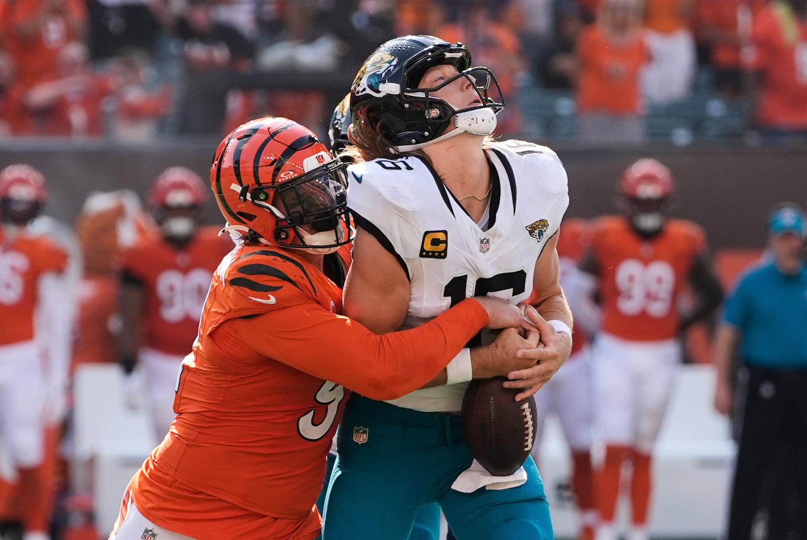Jacksonville Jaguars quarterback Trevor Lawrence (16) is sacked by Cincinnati Bengals defensive end Trey Hendrickson during the second half of an NFL football game, Sunday, Sept. 14, 2025, in Cincinnati. (AP Photo/Carolyn Kaster)