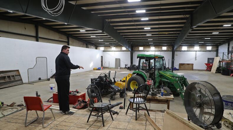 Mark Armstrong describes how he is going to turn the warehouse space at 2001 Lagonda Avenue into the sports complex Wednesday. BILL LACKEY/STAFF