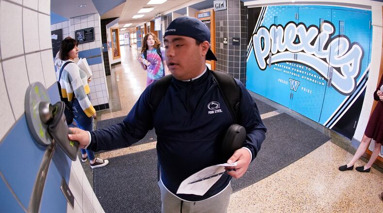 Springfield City School District Board of Education has approved the purchase of Yondr Phone-Free pouches for the 2024-25 school year for students in 7-12 grades. In this AP file photo, Anthony Bruno, a student at the Washington Junior High School, used the unlocking mechanism as he left classes for the day to open the bag that his cell phone was sealed in during the school day, in Washington, Pa. (AP Photo/Keith Srakocic)