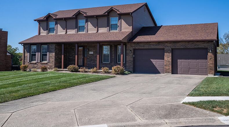 The rear has an oversized wood deck with railings and a partially fenced back yard. CONTRIBUTED PHOTO