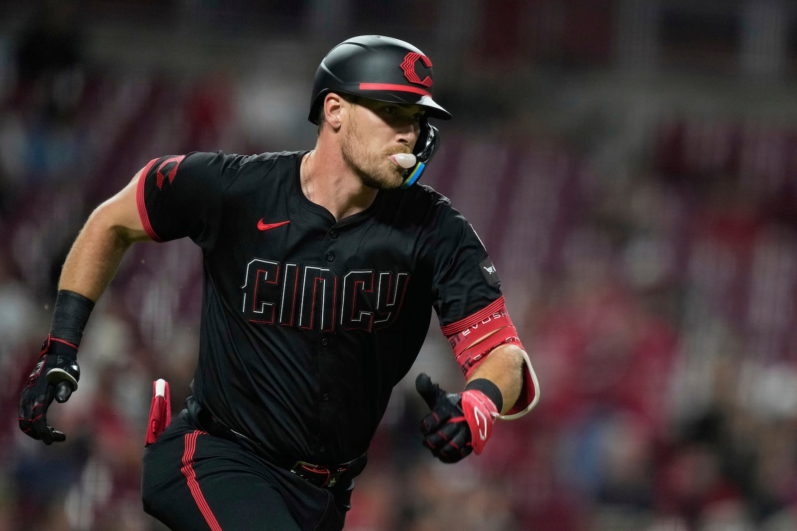 Cincinnati Reds' Tyler Stephenson blows a gum bubble as he runs after hitting a two-RBI double on a line drive against the Washington Nationals during the third inning of a baseball game, Friday, May 2, 2025, in Cincinnati. (AP Photo/Carolyn Kaster)