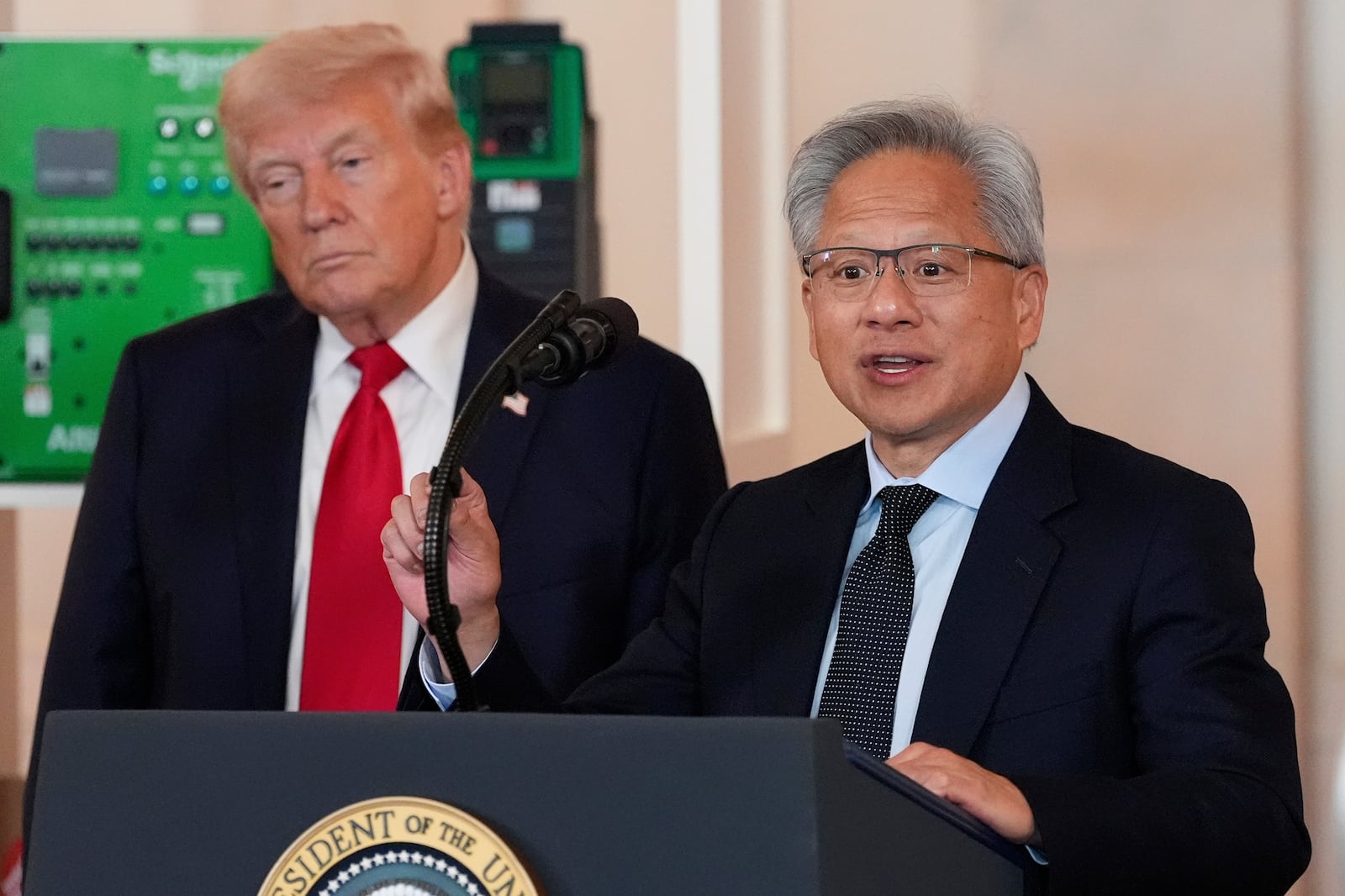 President Donald Trump listens as Nvidia CEO Jensen Huang speaks during an event about investing in America in the Cross Hall of the White House, Wednesday, April 30, 2025, in Washington. (AP Photo/Alex Brandon)