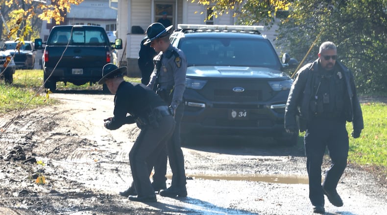 The Springfield Police and State Highway Patrol investigate a scene in an alley between Johnny Lytle and Southern Avenue Tuesday. BILL LACKEY/Staff