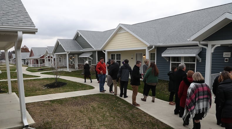 Visitors tour Community Gardens, a senior housing development located where Community Hospital used to be. The 50 unit pocket neighborhood was completed in 2018. Its developers are working on a plan that would add 60-more units there. BILL LACKEY/STAFF