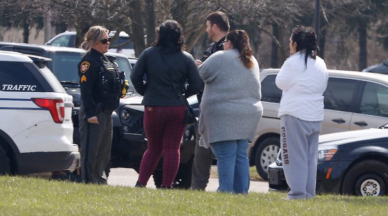 Worried Kenton Ridge High School parents talk to members of the Clark County Sheriff's Department after a false active shooter call was received Tuesday, March 22, 2023. BILL LACKEY/STAFF