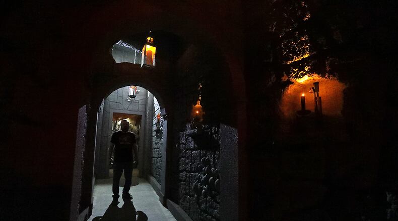 A worker stands in a doorway of the new wine cellar added to the Face Your Fears Hotel of Terror last year. BILL LACKEY/STAFF