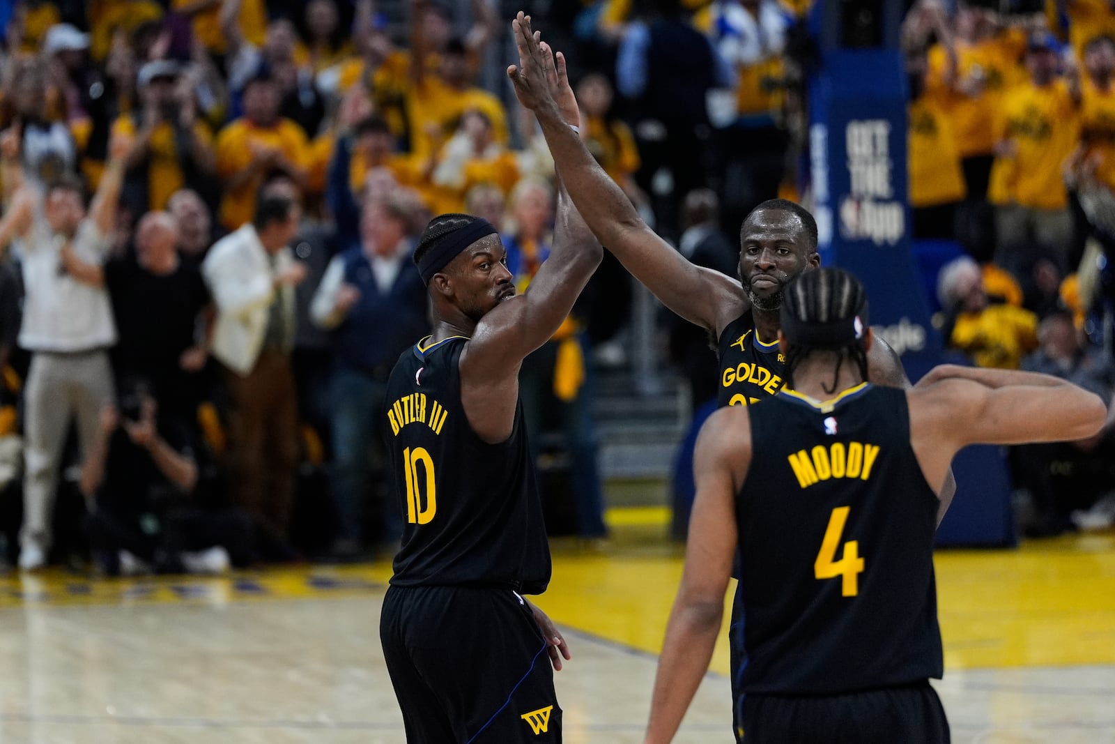 Golden State Warriors forward Jimmy Butler III (10) celebrates with Golden State Warriors forward Draymond Green (23) after scoring during the first half of Game 6 of an NBA basketball first-round playoff series against the Houston Rockets, Friday, May 2, 2025, in San Francisco. (AP Photo/Godofredo A. Vásquez)