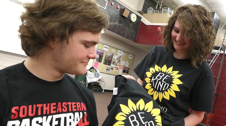 Mozie Van Raaij, a student at Southeastern High School, gives fellow student,Camden Snodgrass, a “Be Kind” t-shirt in class Friday, April 20, 2018. Mozie gave out 200 of the t-shirts after finding an offensive message writen in the locker room recently. BILL LACKEY/STAFF
