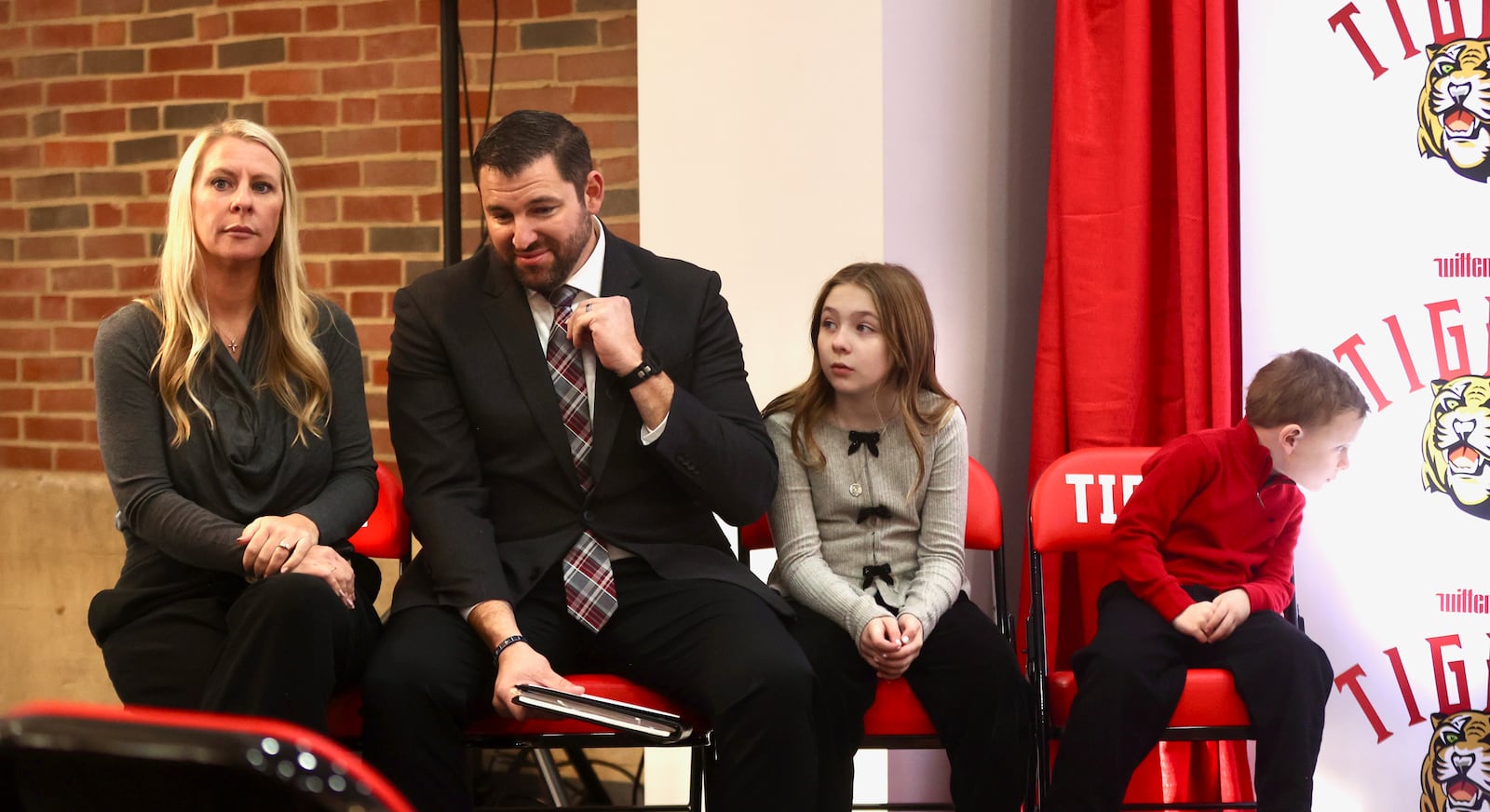 BJ Coad, second from left, sits with his family before being introduced as the new head football coach on Monday, Dec. 1, 2025, at the The Health, Wellness & Athletics Complex in Springfield. Also pictured are his wife Ashley, daughter Cecilia and son Jamey. David Jablonski/Staff