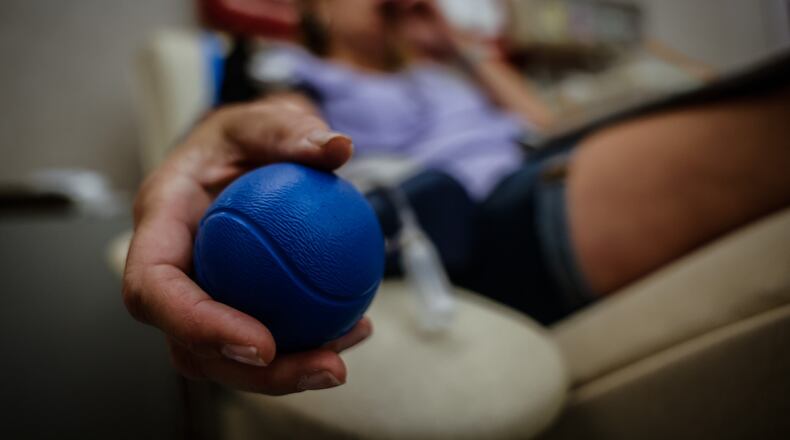 Nancy Gillespie, from Dayton, donates blood at the Dayton Community Blood Center last June. JIM NOELKER/STAFF