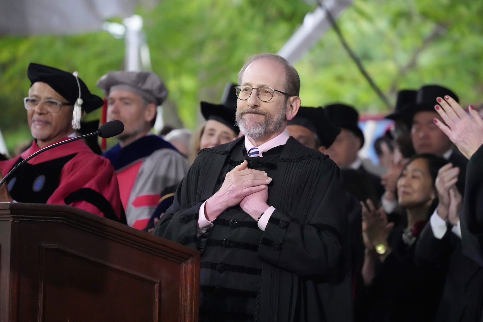 Harvard President Alan Garber acknowledges an extended round of applause during Harvard University's commencement ceremonies, Thursday, May 29, 2025 in Cambridge, Mass. (AP Photo/Charles Krupa)