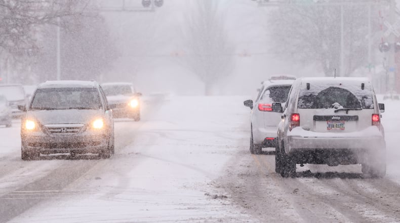 Several inches of snow fell around the Miami Valley on Dec. 13. Vehicles drive on East Main Street in Troy on Saturday, Dec. 13. BRYANT BILLING / STAFF