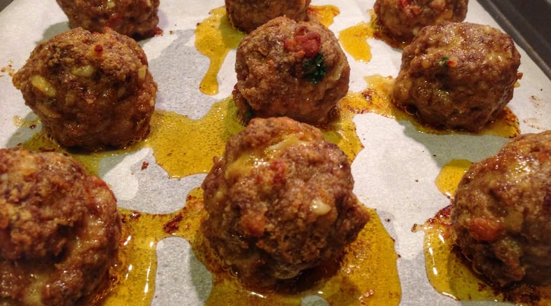 Be sure to use parchment paper in the pan when you bake these Smokn’ Bacon Balls; otherwise, they’ll drip all over the place because they’re loaded with bacon lardons, ground chuck, heavy cream and smoked cheddar. (CONNIE POST/STAFF PHOTO)