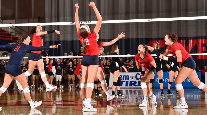 The Dayton volleyball team celebrates a point during a match against Marshall on Aug. 24, 2018, at the Frericks Center in Dayton. Photo by Erik Schelkun
