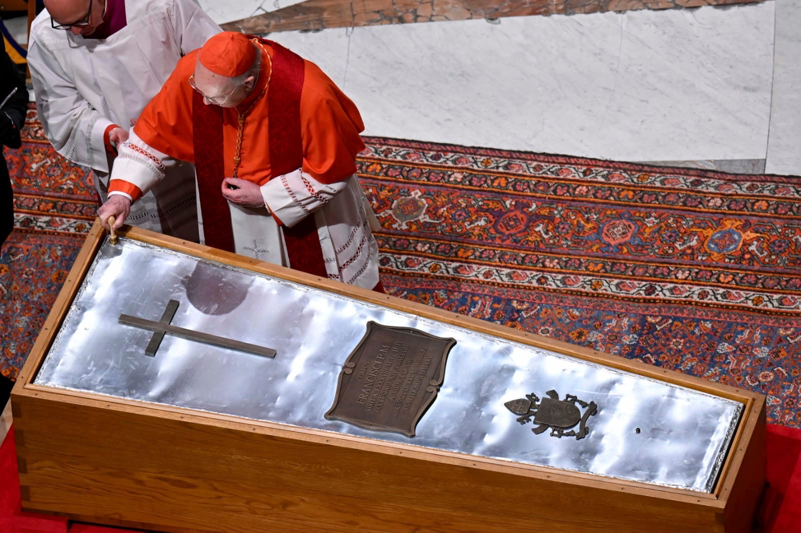Cardianal Camerlengo Kevin Joseph Farrel seals the zinc cover of the casket containing the body of late Pope Francis in St. Peter's Basilica at the Vatican Friday, April 25, 2025. (Vatican Media via AP)
