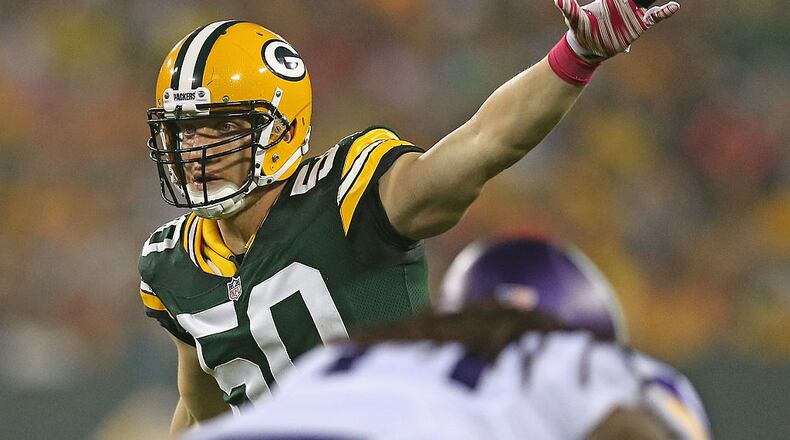 GREEN BAY, WI - OCTOBER 02: A.J. Hawk #50 of the Green Bay Packers calls defensive signals against the Minnesota Vikings at Lambeau Field on October 2, 2014 in Green Bay, Wisconsin. The Packers defeated the Vikings 42-10. (Photo by Jonathan Daniel/Getty Images)