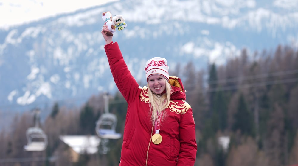 Varvara Voronchikhina, of Russia, smiles on the podium after winning the gold medal in the alpine skiing women's super-G standing at the 2026 Winter Paralympics, in Cortina d'Ampezzo, Italy, Monday, March 9, 2026. (AP Photo/Emilio Morenatti)