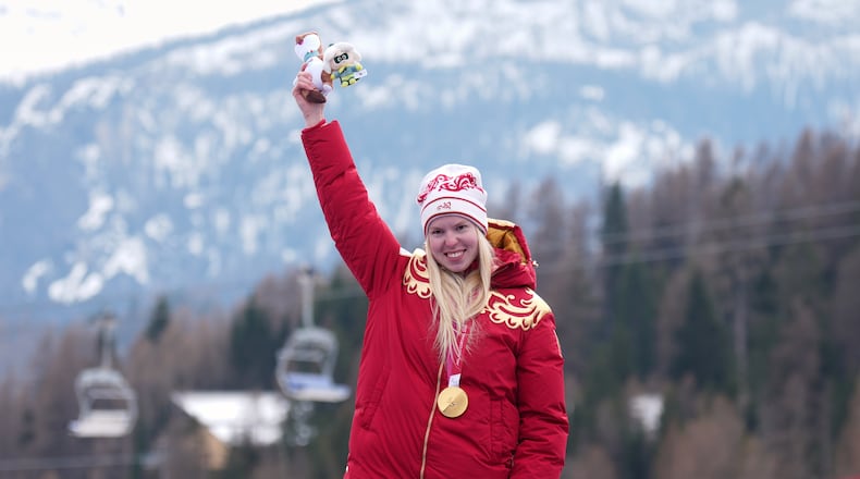Varvara Voronchikhina, of Russia, smiles on the podium after winning the gold medal in the alpine skiing women's super-G standing at the 2026 Winter Paralympics, in Cortina d'Ampezzo, Italy, Monday, March 9, 2026. (AP Photo/Emilio Morenatti)