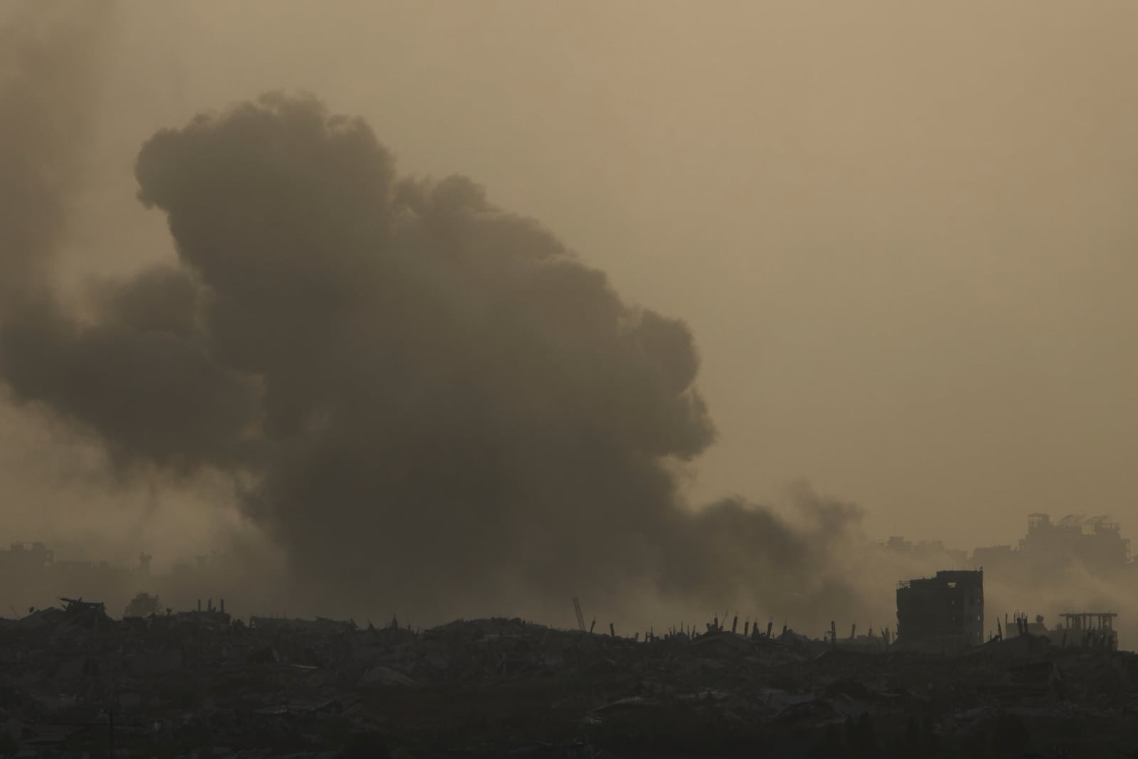 Smoke from an Israeli bombardment billows over the Gaza Strip, seen from southern Israel, Tuesday, July 1, 2025. (AP Photo/Ariel Schalit)