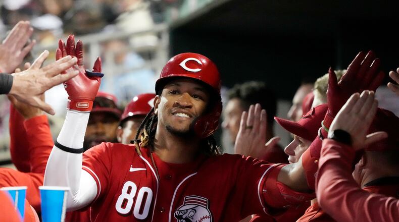 Cincinnati Reds' Allan Cerda (80) celebrates with teammates in the dugout after his two-run home against the Colorado Rockies during the second inning of a spring training baseball game Monday, March 6, 2023, in Goodyear, Ariz. Cerda scored a run and had an RBI in Chattanooga's improbable 7-5 win on Saturday despite no hits. (AP Photo/Ross D. Franklin)