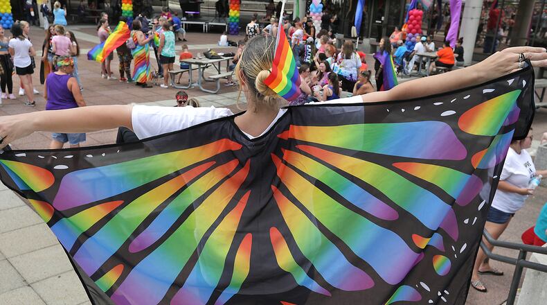 A woman spreads her wings at the 2021 Springfield Pride Festival Saturday on City Hall Plaza. Several. Several hundred people turned out for the entertainment, festivities and to celebrate the LGBTQ community. BILL LACKEY/STAFF