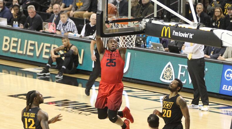 Dayton’s Kendall Pollard dunks against Virginia Commonwealth on Friday, Jan. 27, 2017, at the Siegel Center in Richmond, Va. David Jablonski/Staff