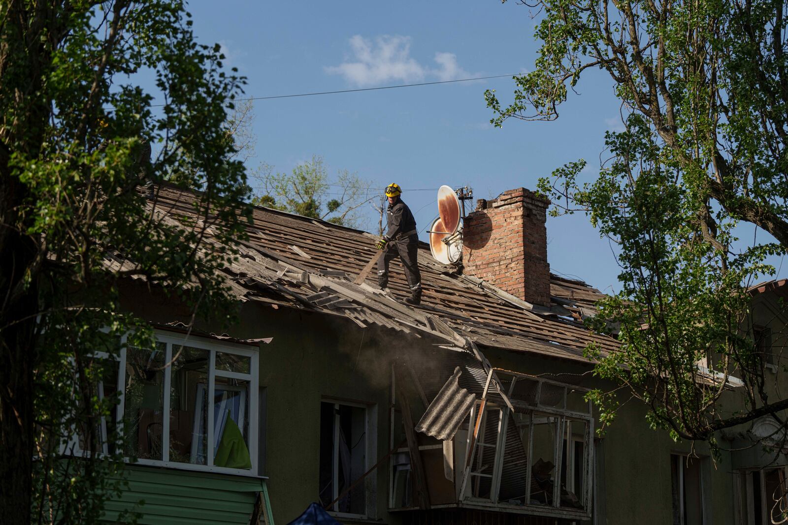A rescue worker clears the rubble of a house damaged by a Russian strike on a residential neighbourhood in Kyiv, Ukraine, on Thursday, April 24, 2025. (AP Photo/Evgeniy Maloletka)