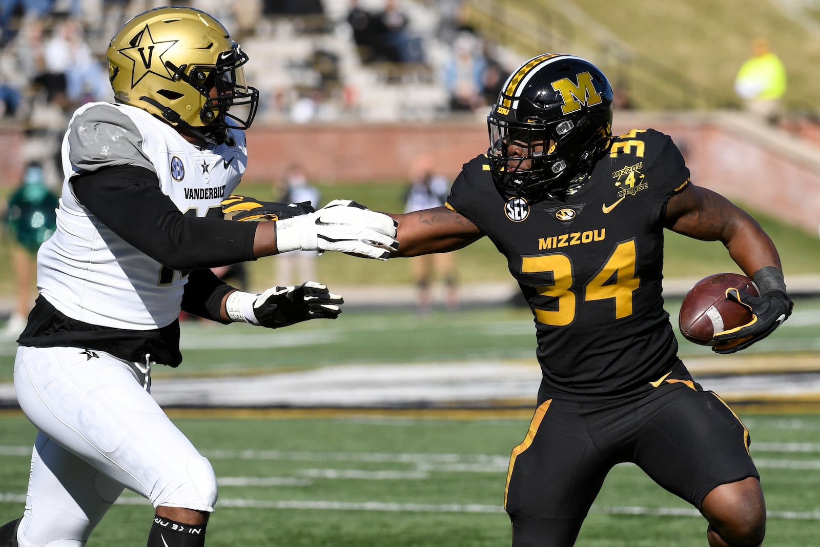 Missouri running back Larry Rountree III (34) runs with the ball as Vanderbilt defensive lineman Dayo Odeyingbo (10) defends during the first half of an NCAA college football game Saturday, Nov. 28, 2020, in Columbia, Mo. (AP Photo/L.G. Patterson)