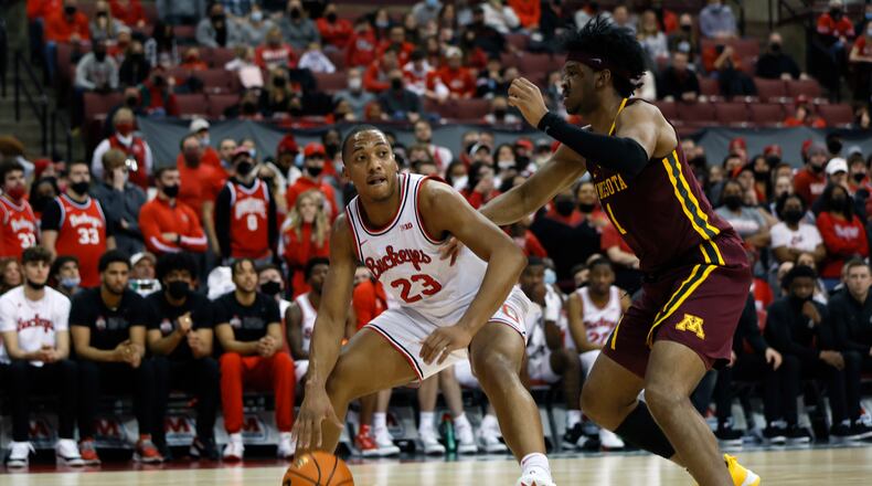 Ohio State's Zed Key, left, looks for an open pass as Minnesota's Eric Curry defends during the second half of an NCAA college basketball game Tuesday, Feb. 15, 2022, in Columbus, Ohio. (AP Photo/Jay LaPrete)