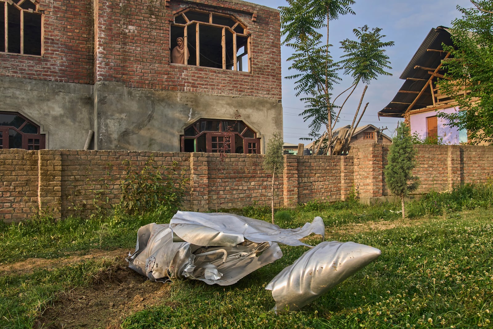 Debris of what looks like parts of an aircraft lie at the backyard of a house at Pampore in Pulwama district of Indian controlled Kashmir, Wednesday, May 7, 2025. (AP Photo/Dar Yasin)