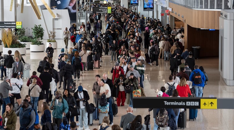 Travelers wait in a TSA line, Wednesday, March 25, 2026, at LaGuardia Airport in New York. (AP Photo/Yuki Iwamura)