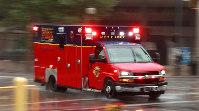 A Springfield Fire Rescue Division medic unit races through the rain downtown en route to a call Thursday, July 6, 2023. BILL LACKEY/STAFF