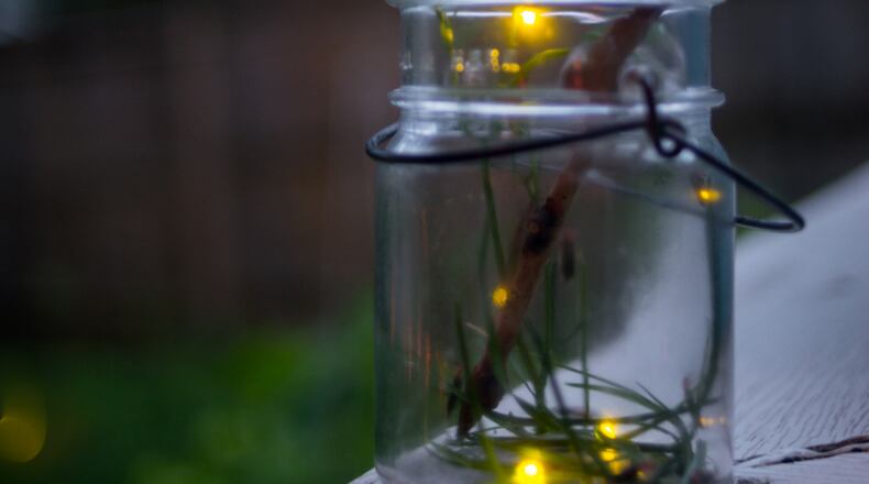 Fireflies in a mason jar on a summer evening. iSTOCK/COX