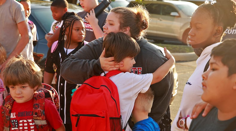 Aiden Watts gets a hug from his mom, Caitlin Richards, and his little brother before going in to Fulton Elementary on the first day of school Wednesday, August 14, 2024. BILL LACKEY/STAFF