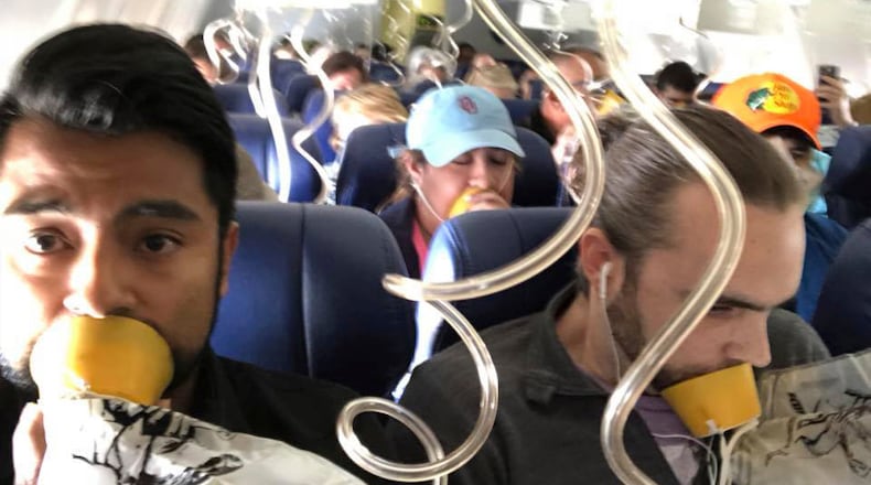 In this April 17, 2018 photo provided by Marty Martinez, Martinez, left, appears with other passengers after a jet engine blew out on the Southwest Airlines Boeing 737 plane he was flying in from New York to Dallas, resulting in the death of a woman who was nearly sucked from a window during the flight with 149 people aboard. A preliminary examination of the blown jet engine that set off a terrifying chain of events showed evidence of “metal fatigue,” according to the National Transportation Safety Board. (Marty Martinez via AP)