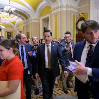 Sen. Bernie Moreno, R-Ohio, center, talks with reporters as he walks through the Ohio Clock Corridor at the Capitol, Tuesday, Jan. 13, 2026, in Washington. (AP Photo/Rod Lamkey, Jr.)