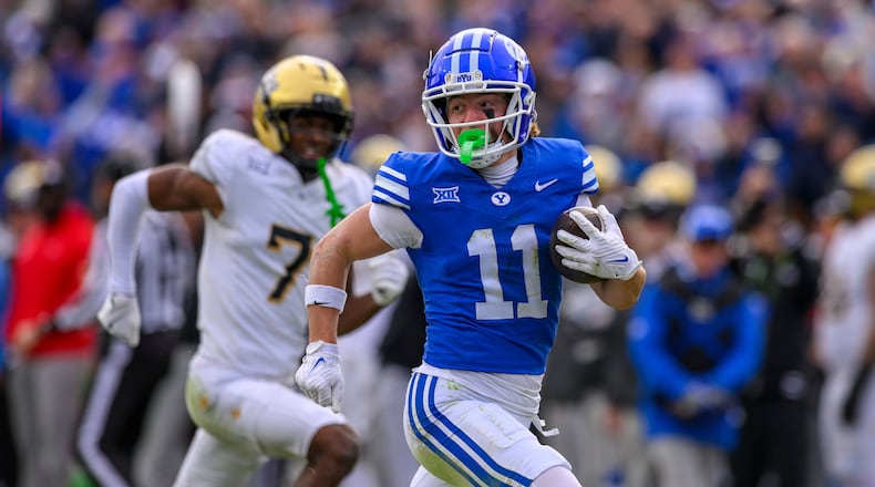 FILE - BYU wide receiver Parker Kingston (11) runs the ball in for a touchdown during the second half an NCAA college football game against UCF, Nov. 29, 2025, in Provo, Utah. (AP Photo/Tyler Tate, File)