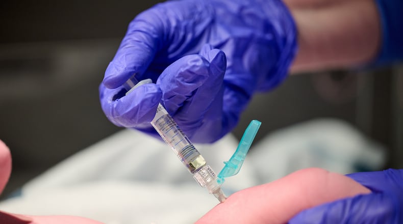 In this photo provided by Norton Healthcare, nurse Robin Waldridge administers a Vitamin K shot to a newborn baby at Norton Women's and Children's Hospital on Friday, March 6, 2026, at the hospital in Louisville, Ky. (Jamie Rhodes/Norton Healthcare via AP)