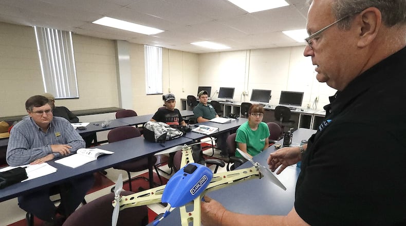 Clark State Community College instructors Larry Everett talks about the GPS device that’s in a UAV during a precision agriculture class. Bill Lackey/Staff