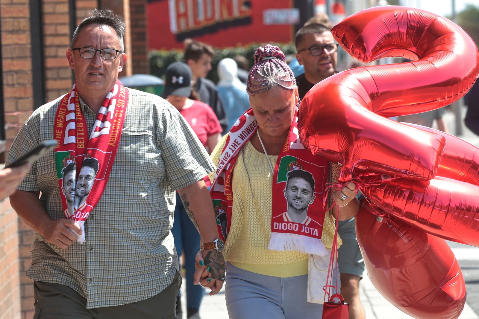 People arrive to leave tributes in memory of Liverpool player Diogo Jota at Anfield Stadium, home of FC Liverpool in Liverpool, Thursday, July 3, 2025.(AP Photo/Ian Hodgson)