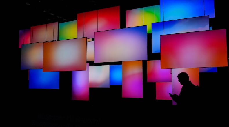 A Person walks past a wallpaper TV display at the LG booth during the CES tech show Wednesday, Jan. 7, 2026, in Las Vegas. (AP Photo/John Locher)